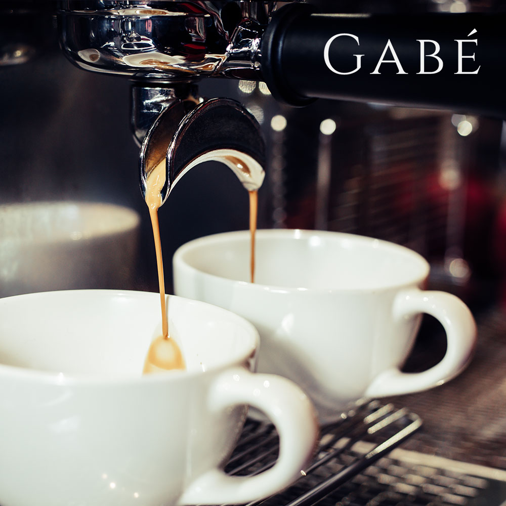 Barista using coffee machine in the cafe.